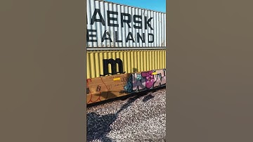 BNSF power hides in the background as a double stack intermodal train speeds by #drone #train