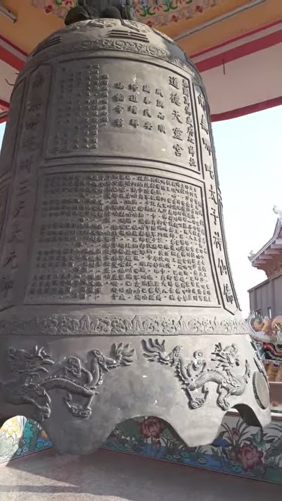 Maya ringing a huge bell at chinese temple, pattaya