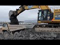 Cat 374F LME and Komatsu HD 405's hauling blasted limestone from barge