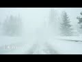 point of view driving through heavy snowfall on road in sweden