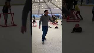 Girl on ice skates falls then accidentally tips little boy on ice skating rink