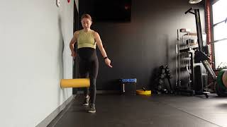 Standing hip shift with foam roller internal hip rotation feedback