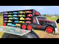 Colorful cars  large black truckslets pick up a minicar and put it on