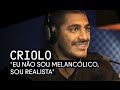 O rapper Criolo rebate as críticas e diz que não é triste, e sim, realista