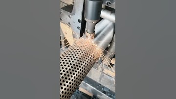 drilling holes in the iron plate to make the exhaust filter