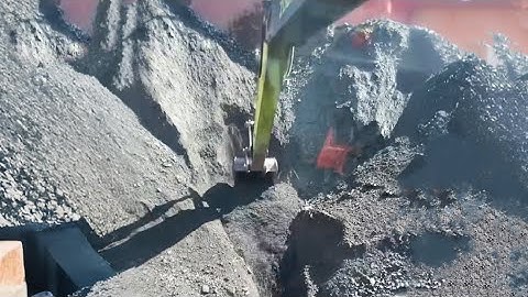 Barge unloading 4900 tons of crushed phosphate rock - Empty Barge End - Excavator working on barge