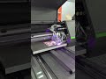 Watch the 6090 UV Printer auto-print a vibrant masterpiece! 🎨 Perfect colors, flawless details.