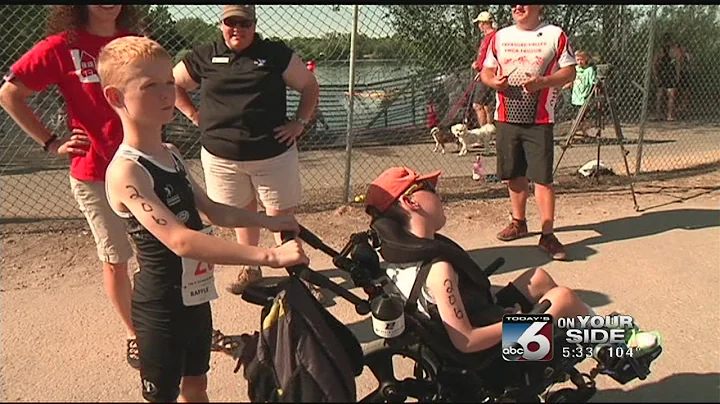 Eight year old helps disabled brother compete in t...