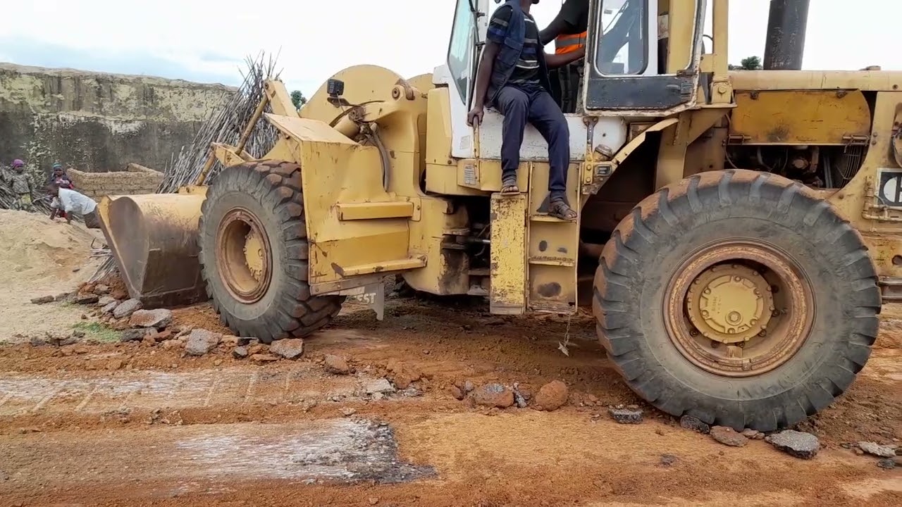 Payloader Machine scraping Asphalt