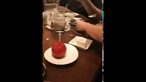 Attempting to eat the candied apple