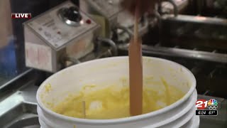 Arielle, at the fair, learns how to make a corndog