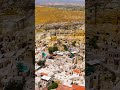 Vertical video. Urgup, Nevsehir, Turkey. Hotels with rooms at cliff base and carved into rock for...