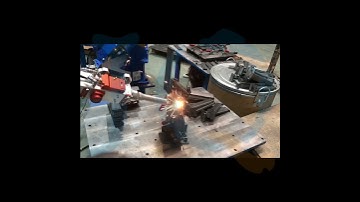 In a metal processing factory, how are the robotic arms used for welding