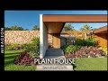 Internal courtyards and walkways connect the pieces of the plain house