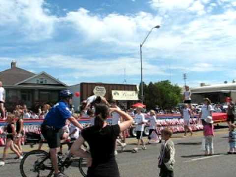 Bike Cop Hypnotized by Gymnasts Parade Float Falls on the ground