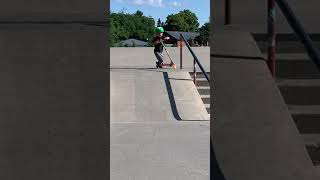 Boy rides scooter downhill at skatepark then trips and faceplants into scorpion position