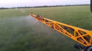 Dmytro spraying winter wheat with  Hagie sts 12 sprayer