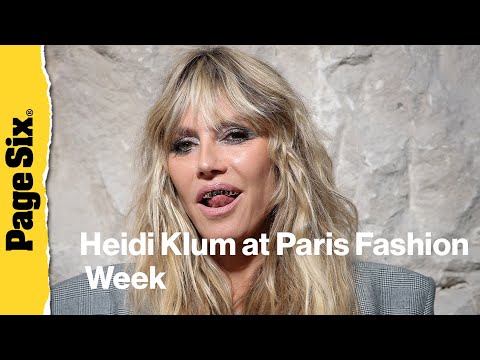 Heidi Klum pairs completely see-through lace dress with a platinum grill at Vetements show during...