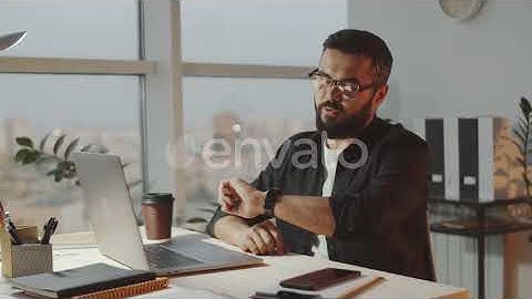 Bearded Businessman Video Calling on Laptop in Office | Stock Footage - Envato elements