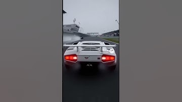 Lamborghini Countach 25th Anniversary White  racing in F1 Japanese Grand Prix at Suzuka Circuit