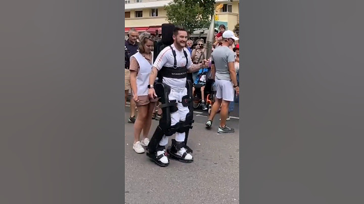Paraplegic Kevin Piette carrying the Olympic torch in his new exoskeleton