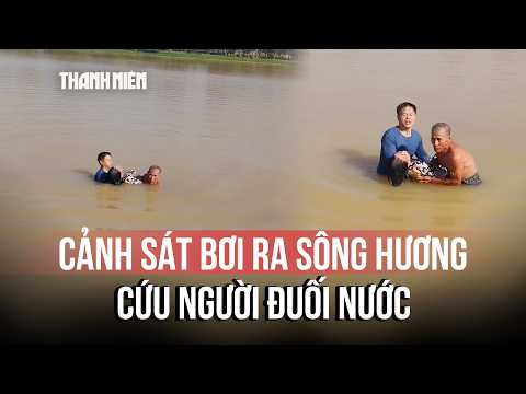 The moment a water police officer swims into the Perfume River to rescue a drowning person
