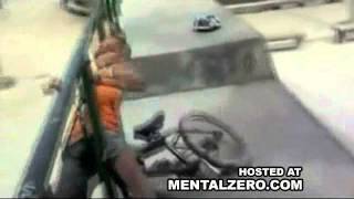 Kid on bmx falls out of half-pipe