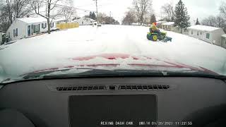 Dashcam - Man on tractor plowing driveway backs up into the road without looking