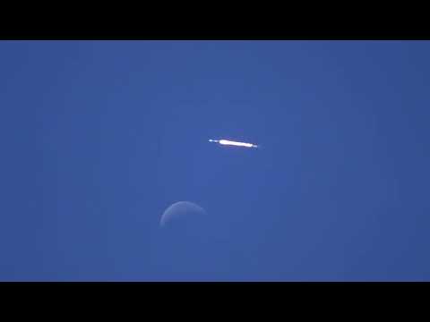 SpaceX Falcon 9 rocket soars past daytime moon during launch