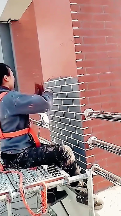 Decoration process of red latex paint on exterior brick walls
