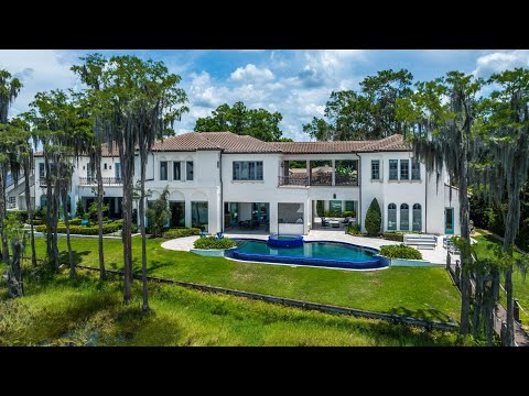 This $6,670,000 Elegant Home in Orlando has a resort style backyard and a stone driveway