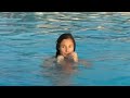 Girl swims in the pool