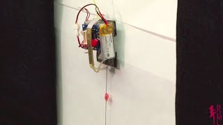 Micro robot climbs vertical glass carrying 100 times its weight