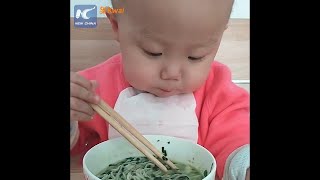 Adorable: Two-year-old baby using chopsticks like a pro