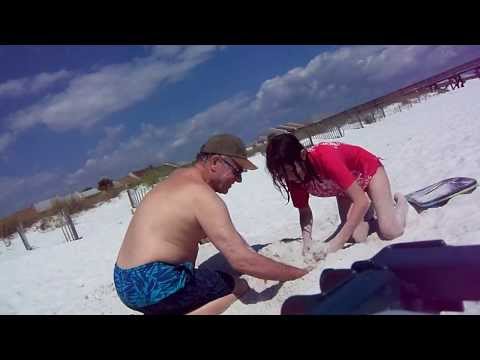 KID BURIED IN SAND SCREAMS WHEN HIS FEET ARE TICKLED