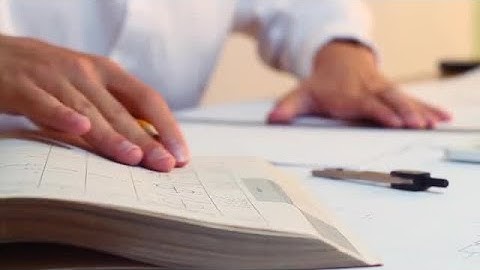 Engineer Reading Calculations While Drawing Stock Video