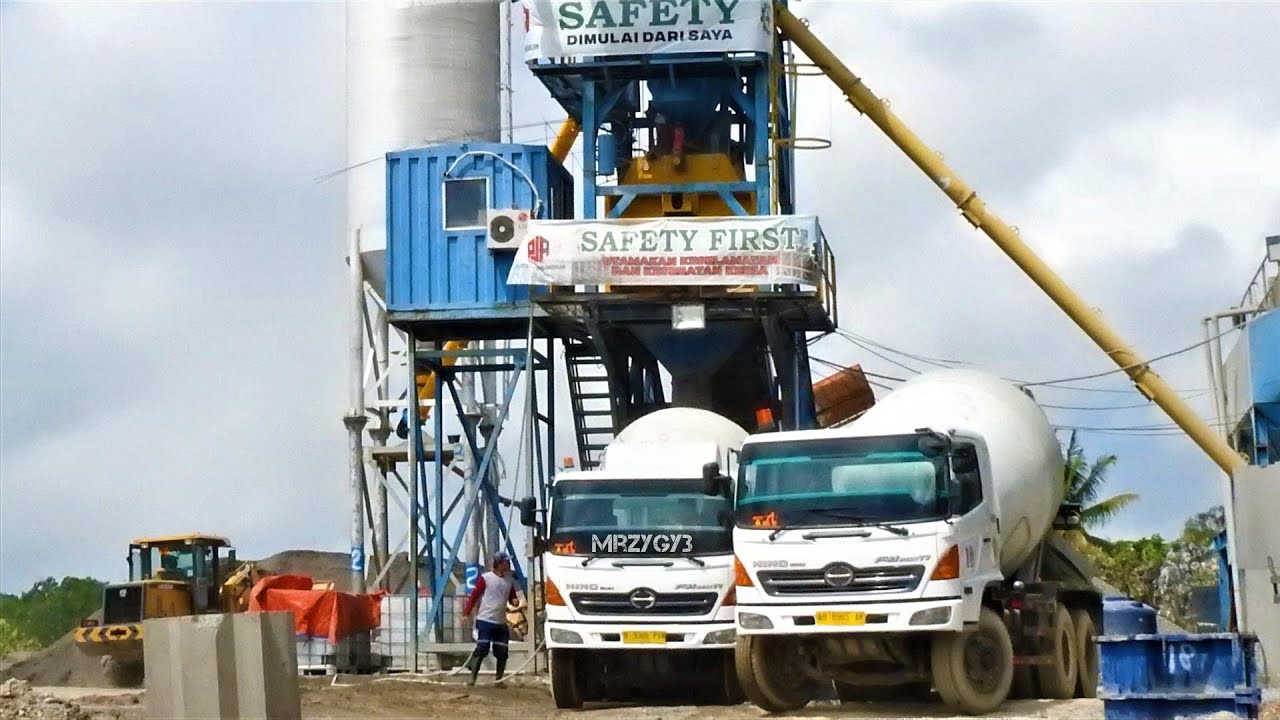 Ready Mix Concrete Cement Trucks Working On Breakwater Tetra Pod Batch