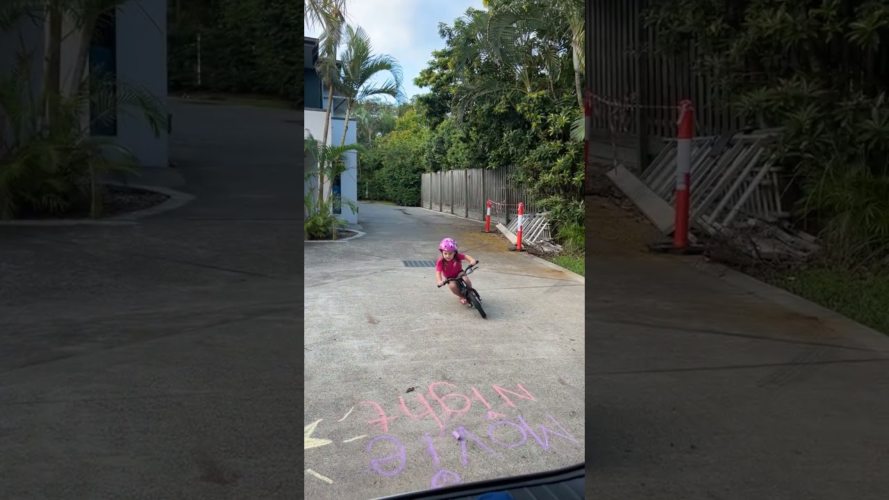 Girl wearing helmet rides electric bike around in a circle then falls and faceplants