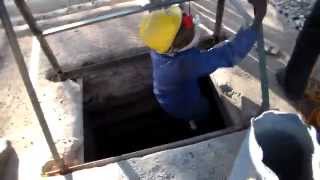 Emerging miner coming out of antimony mine shaft via winch hoist