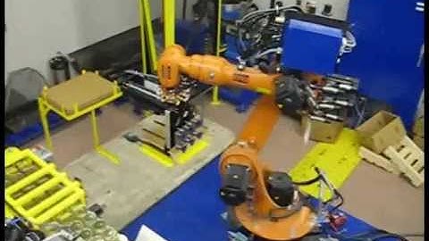 Kuka robot boxing jars and stacking boxes on pallets
