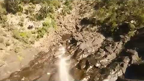 Drone Crashes Into Tree and Falls in Rocky Terrain of Valley - 1154047