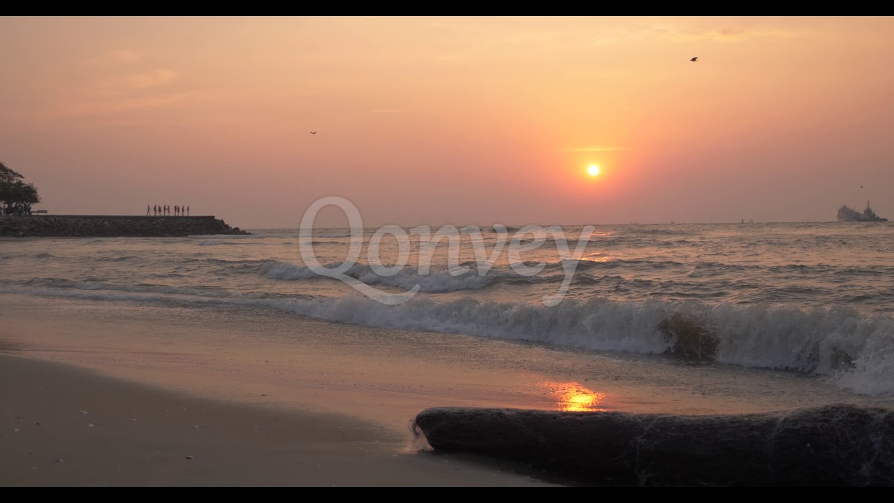 Beach sunset wide shot with people Slow motion | Stock Video | Qonvey