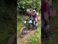 A woman was riding her motorcycle up a hill when it broke down.