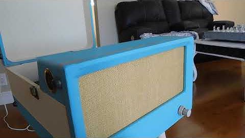 Zenith 4 speed automatic portable record player playing a couple 45