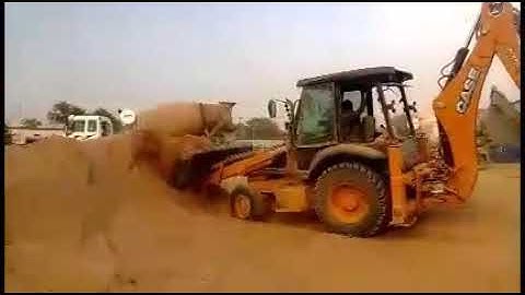 Case 770 loader backhoe loading material