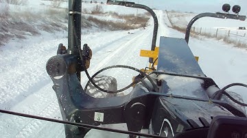 Snow grading John Deere 770G