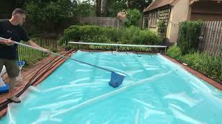 7: Scooping leaves off top of Solar pool cover.