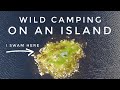 Wild camping on an island in the mountains swimming to a remote camping spot on a lake