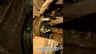 Disconnect the radiator hose connected to the thermostat housing.