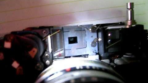 How is frameline parallax correction achieved in rangefinder cameras?